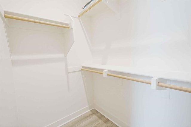 walk in closet featuring light wood finished floors