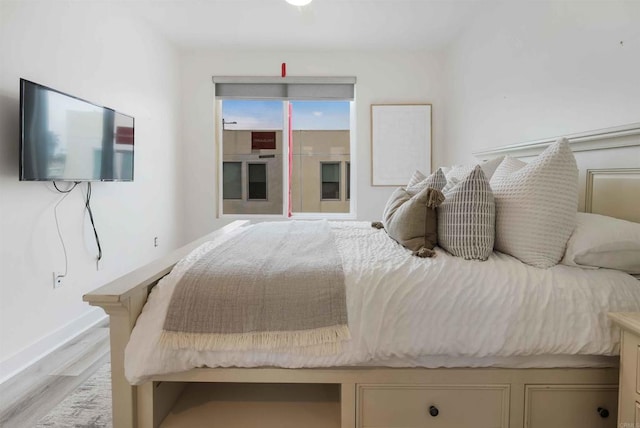 bedroom with light wood-style floors and baseboards