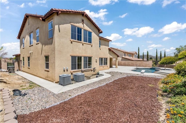 44557 Howell Mountain St, Temecula, CA 92592 - rear view of house featuring a patio, central AC unit, stucco siding, and a fenced in pool