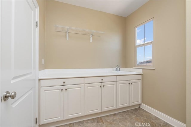 44557 Howell Mountain St, Temecula, CA 92592 - laundry room featuring baseboards and a sink
