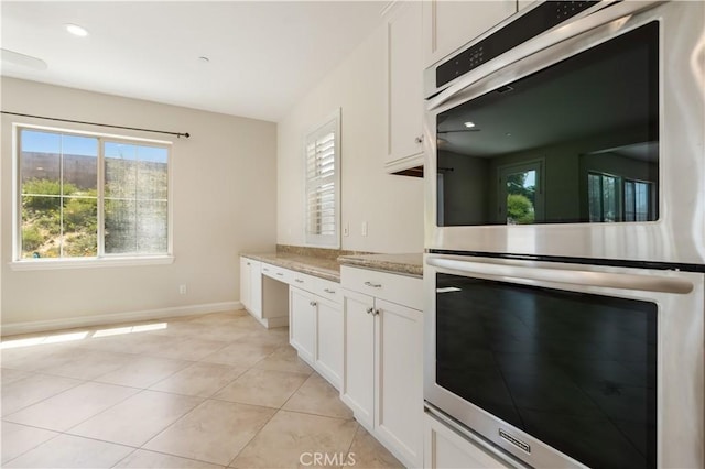 44557 Howell Mountain St, Temecula, CA 92592 - kitchen featuring baseboards, stainless steel double oven, light tile patterned flooring, and white cabinets