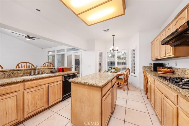 kitchen featuring visible vents, a sink, black appliances, light brown cabinets, and under cabinet range hood