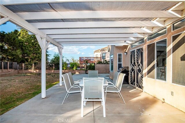 view of patio / terrace featuring fence and outdoor dining area