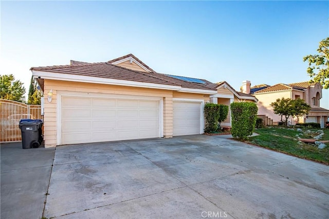 single story home with solar panels, driveway, and a tile roof