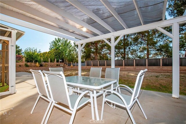 view of patio with outdoor dining area and a fenced backyard