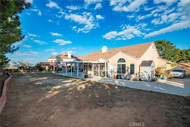 back of house with a patio, stucco siding, and a pergola