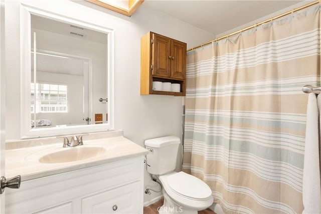 bathroom featuring vanity, toilet, and a shower with shower curtain