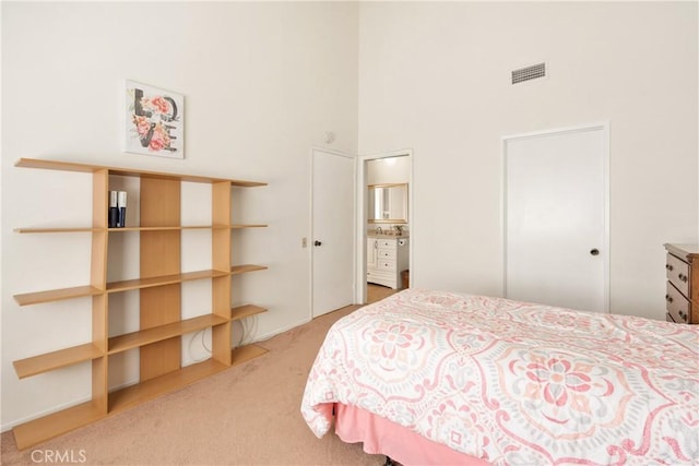 carpeted bedroom with a towering ceiling and visible vents