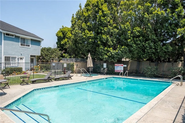 pool featuring fence and a patio