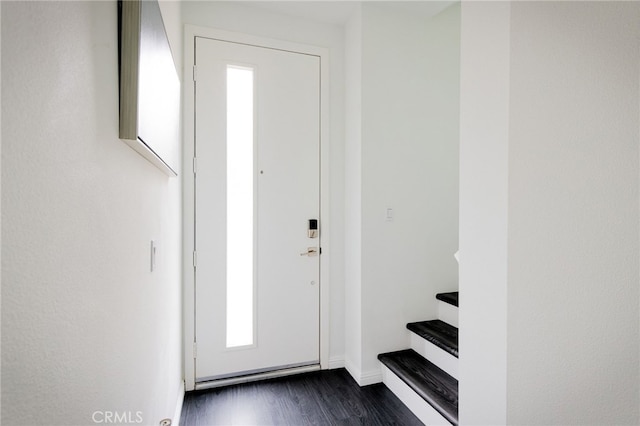 doorway to outside with dark wood-type flooring and baseboards