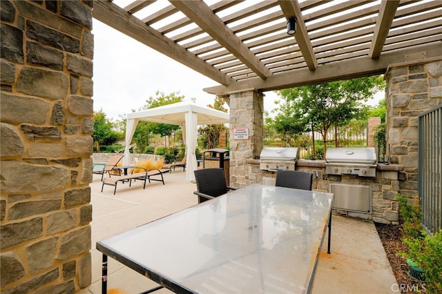 view of patio with exterior kitchen, outdoor dining area, grilling area, and a pergola