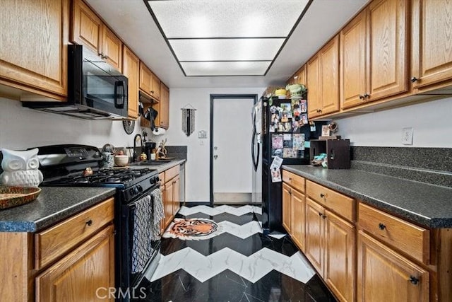 2129 El Domingo Cir Unit 19, Lancaster, CA 93536 - kitchen featuring a sink, dark countertops, black appliances, and brown cabinets