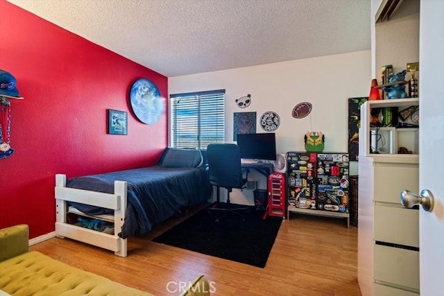 2129 El Domingo Cir Unit 19, Lancaster, CA 93536 - bedroom featuring a textured ceiling and wood finished floors