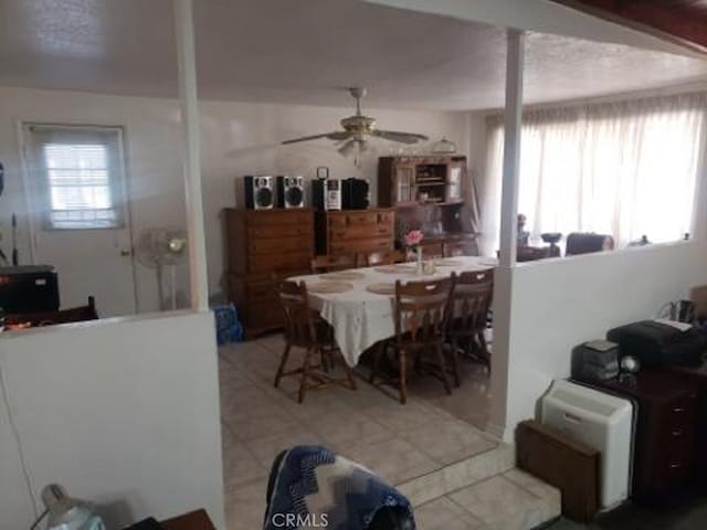 dining room with light tile patterned floors, plenty of natural light, and ceiling fan