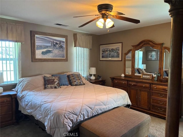 bedroom featuring a ceiling fan, light colored carpet, and visible vents