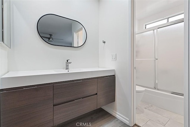 5461 Newcastle Ave Unit 14, Encino, CA 91316 - full bathroom featuring vanity, shower / bath combination with glass door, toilet, baseboards, and ceiling fan