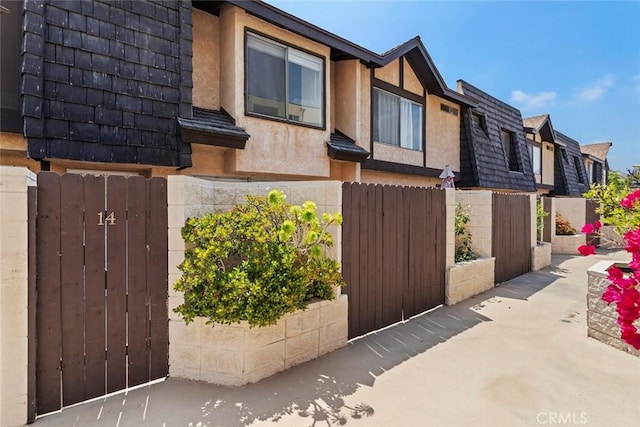 5461 Newcastle Ave Unit 14, Encino, CA 91316 - exterior space with stucco siding, a gate, fence, and a residential view