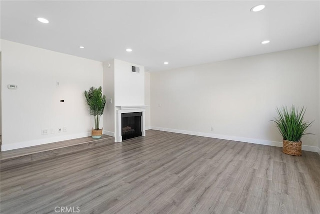 5461 Newcastle Ave Unit 14, Encino, CA 91316 - unfurnished living room featuring visible vents, recessed lighting, baseboards, and wood finished floors