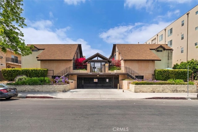 5461 Newcastle Ave Unit 14, Encino, CA 91316 - view of front of house with stairs and stucco siding