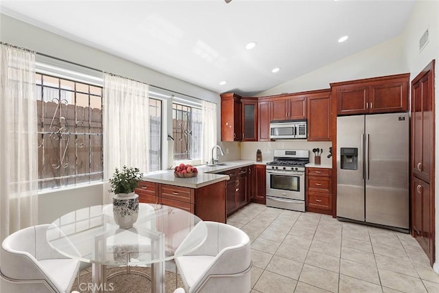 5461 Newcastle Ave Unit 14, Encino, CA 91316 - kitchen featuring light tile patterned floors, glass insert cabinets, stainless steel appliances, light countertops, and lofted ceiling