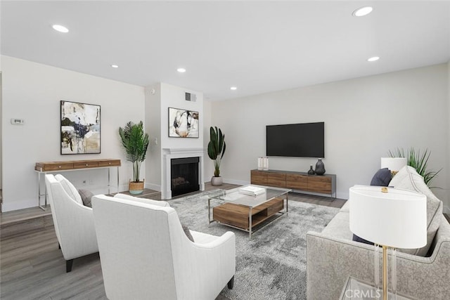 5461 Newcastle Ave Unit 14, Encino, CA 91316 - living area featuring recessed lighting, baseboards, visible vents, wood finished floors, and a fireplace
