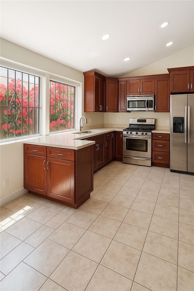 5461 Newcastle Ave Unit 14, Encino, CA 91316 - kitchen with lofted ceiling, stainless steel appliances, recessed lighting, a sink, and light countertops