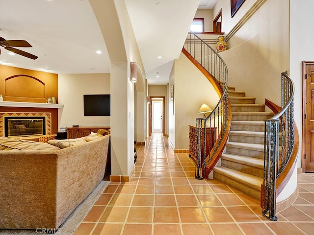 508 Lantern Crest Dr, Redlands, CA 92373 - entrance foyer with light tile patterned floors, ceiling fan, a fireplace, and stairs