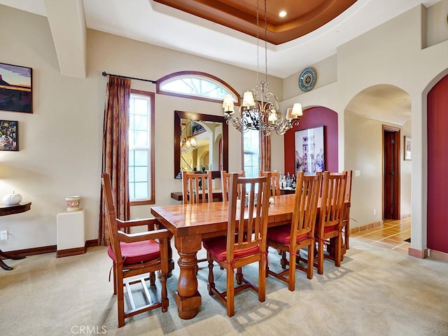508 Lantern Crest Dr, Redlands, CA 92373 - dining space with arched walkways, baseboards, light carpet, and a notable chandelier