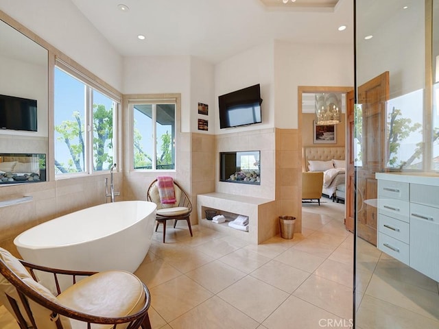 508 Lantern Crest Dr, Redlands, CA 92373 - bathroom featuring a fireplace, a soaking tub, tile walls, tile patterned floors, and recessed lighting