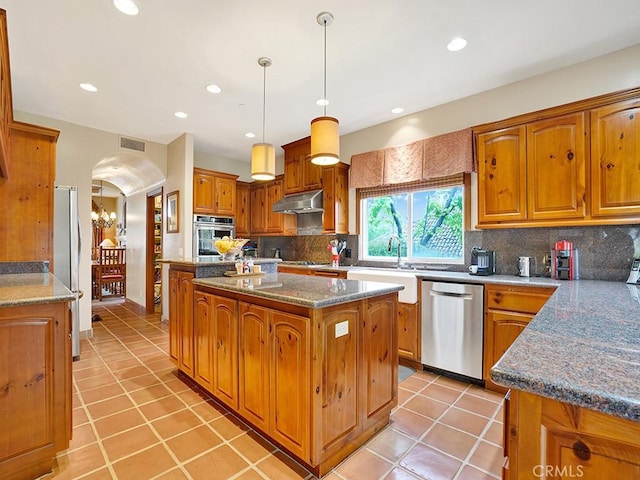508 Lantern Crest Dr, Redlands, CA 92373 - kitchen with a kitchen island, brown cabinets, a sink, light tile patterned floors, and stainless steel appliances