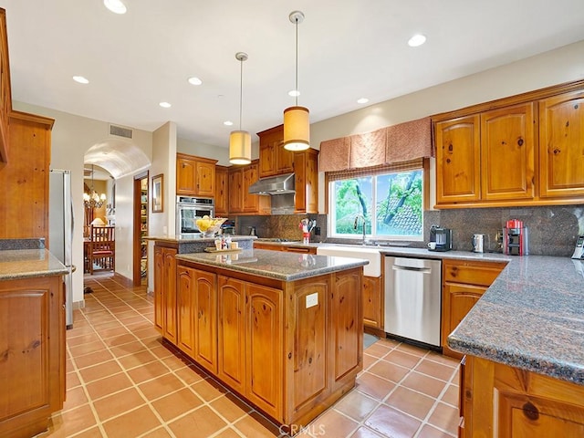 508 Lantern Crest Dr, Redlands, CA 92373 - kitchen featuring appliances with stainless steel finishes, under cabinet range hood, a center island, light tile patterned floors, and recessed lighting
