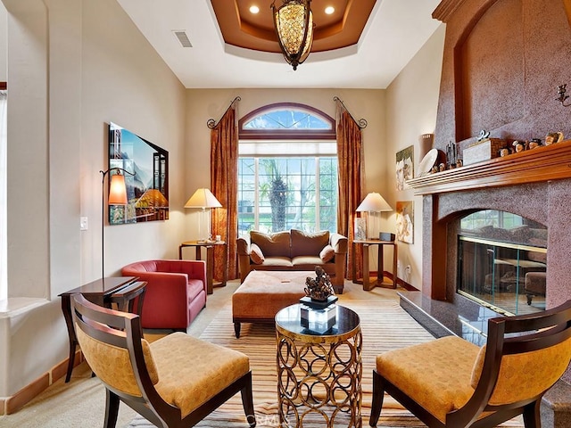 508 Lantern Crest Dr, Redlands, CA 92373 - sitting room featuring visible vents, baseboards, recessed lighting, a high end fireplace, and a tray ceiling