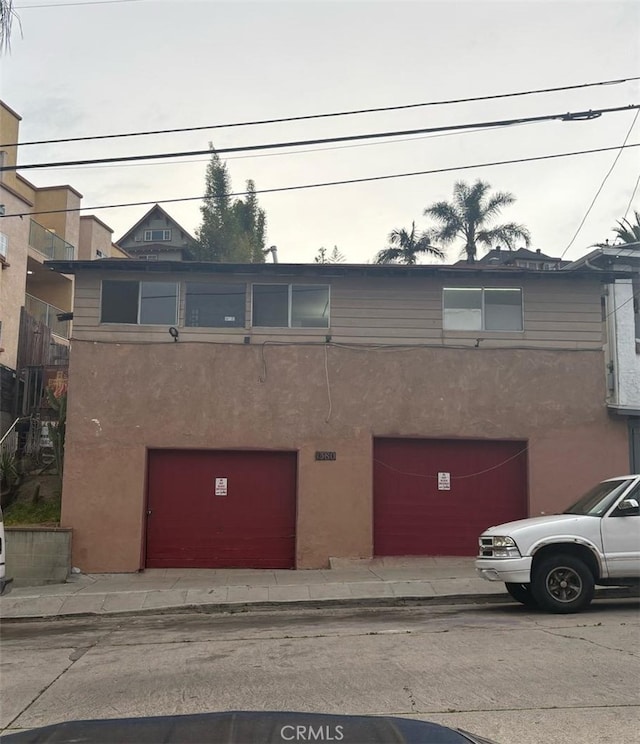 townhome / multi-family property with an attached garage and stucco siding