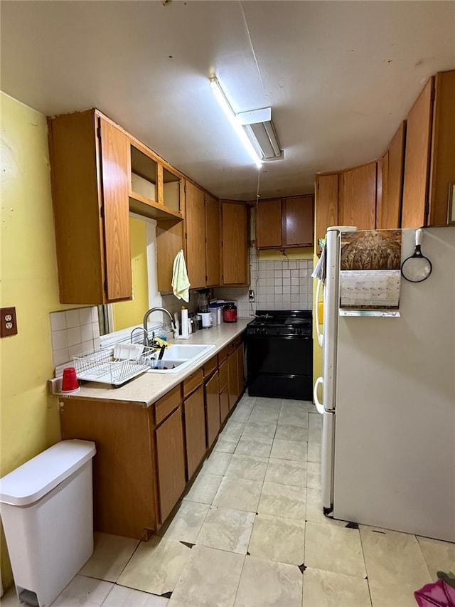 1380 Allison Ave, Los Angeles, CA 90026 - kitchen with black gas range, freestanding refrigerator, brown cabinetry, and decorative backsplash