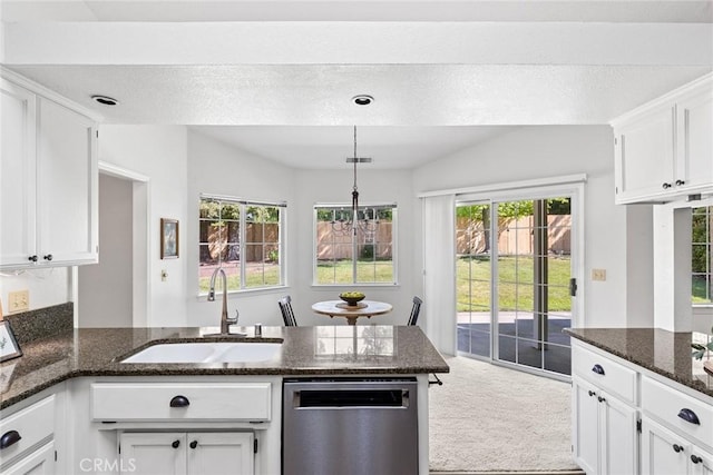 kitchen with a sink, a peninsula, dishwasher, and white cabinets