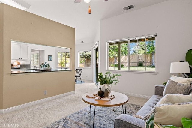 living room featuring light colored carpet, visible vents, and plenty of natural light