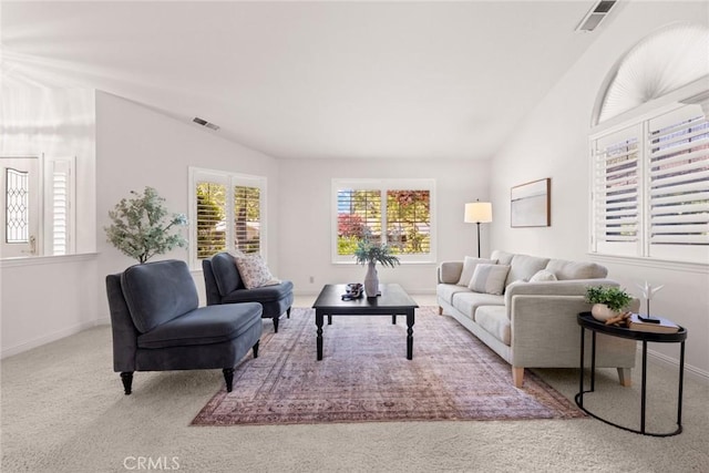 living room featuring a healthy amount of sunlight, carpet flooring, and visible vents