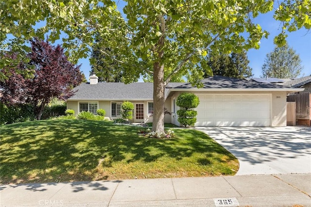 ranch-style home with a front yard, a garage, fence, concrete driveway, and stucco siding