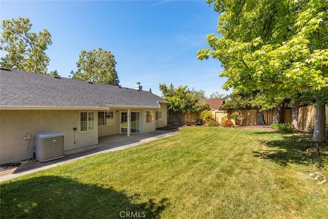 view of yard with central AC unit, a patio area, and a fenced backyard