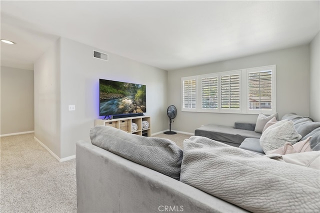 carpeted living room with baseboards and visible vents