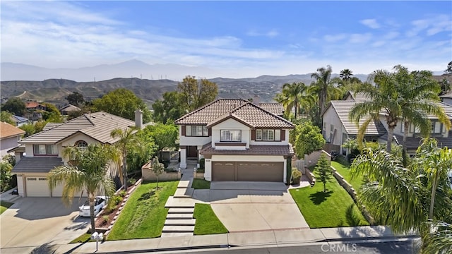 traditional-style house with an attached garage, driveway, a tile roof, and stucco siding