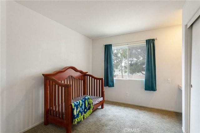 carpeted bedroom featuring baseboards