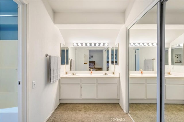 full bath with double vanity and a sink