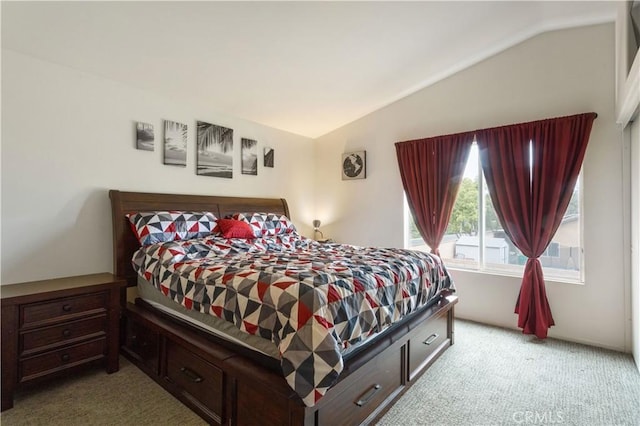 bedroom featuring vaulted ceiling and light colored carpet