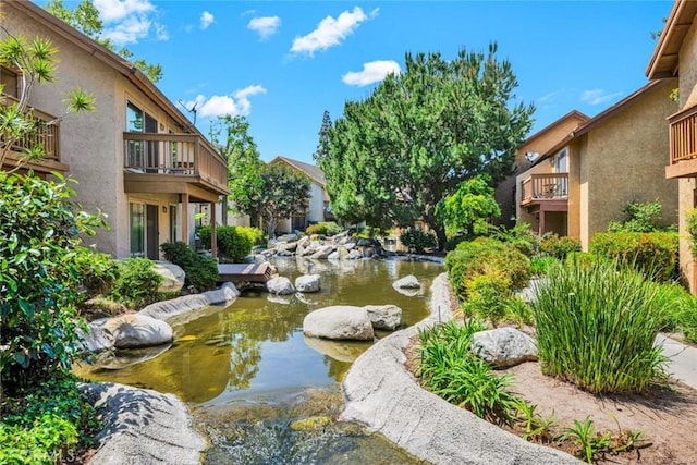view of community with a garden pond