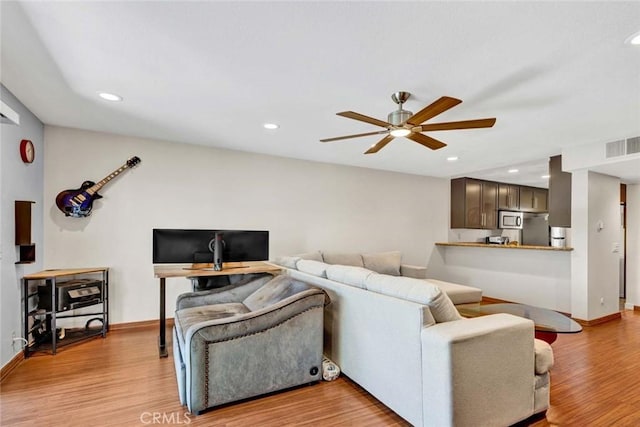 living room featuring recessed lighting, ceiling fan, visible vents, and light wood-style floors