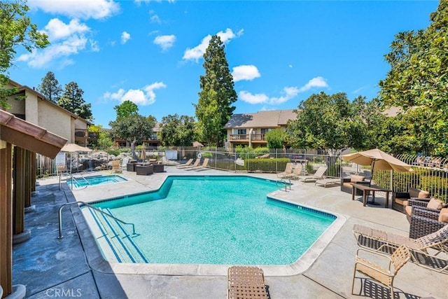 pool featuring a patio and fence