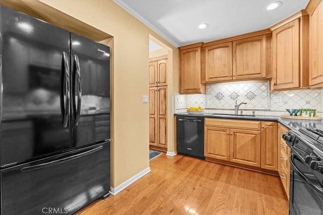 8212 Reading Ave, Los Angeles, CA 90045 - kitchen with black appliances, a sink, light wood finished floors, decorative backsplash, and dark countertops