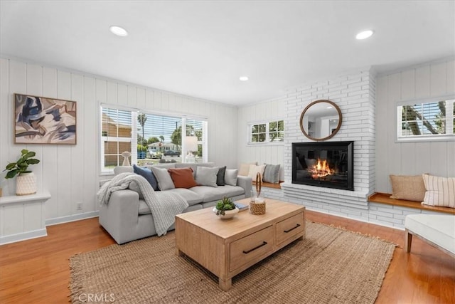 8212 Reading Ave, Los Angeles, CA 90045 - living area featuring light wood finished floors, healthy amount of natural light, a fireplace, a decorative wall, and recessed lighting