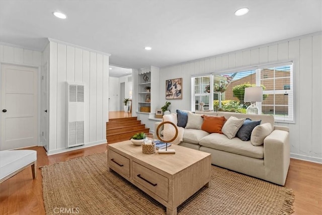 8212 Reading Ave, Los Angeles, CA 90045 - living room featuring a heating unit, light wood-type flooring, stairs, ornamental molding, and recessed lighting